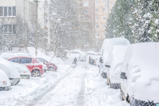 Snow-covered street/ Snowstorm Snow-covered street and cars with a lonely pedestrian. Heavy snowstorm lviv photos stock pictures, royalty-free photos & images