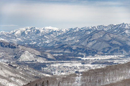 Snowed mountain ridge and village on the valley. Hakuba, Nagano prefecture.