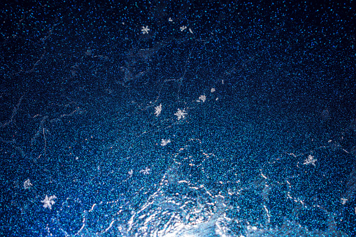 Snowflakes land on a reflective surface on a frigid night in Alaska