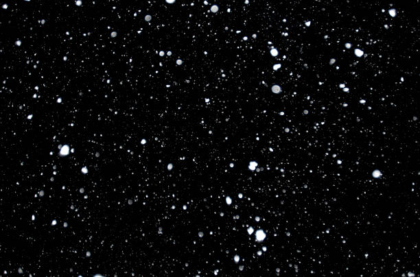 Snowflakes Snow storm captured against black night sky, nature background. sky only stock pictures, royalty-free photos & images