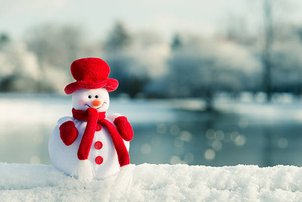 Snowman and winter landscape in the background stock photo
