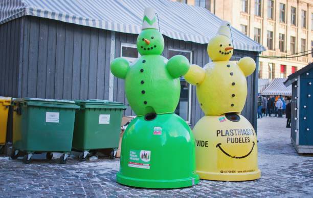 Snowman shaped trash bins for glass and plastic recycling at Christmas market stock photo