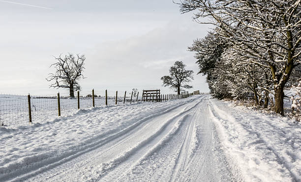 Snowy country lane in Cumbria stock photo