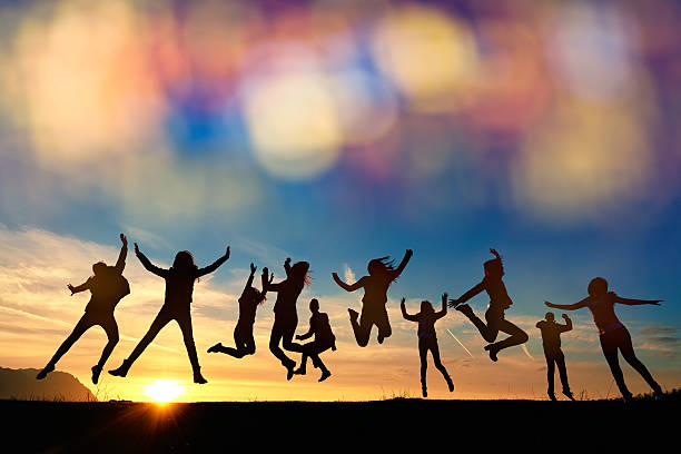 so energic friends jumping at sunset stock photo