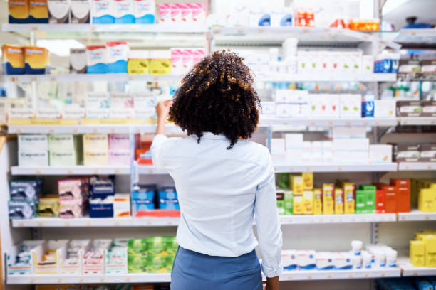 So many choices Rearview shot of a young woman looking at products in a pharmacy antibiotic photos stock pictures, royalty-free photos & images