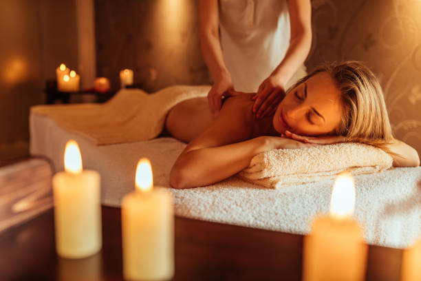 Soaked up in the serenity Young woman enjoying a massage at a spa massage stock pictures, royalty-free photos & images