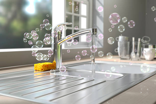 Soap bubbles floating around kitchen sink while washing dish A lot of soap bubbles floating in the air at a kitchen environment washing dishes. sink stock pictures, royalty-free photos & images