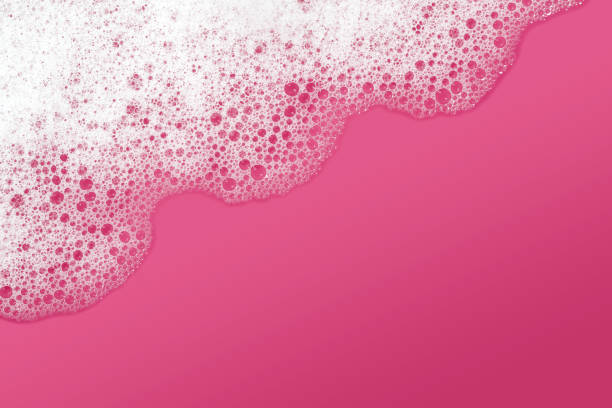 Soap sud background (pink) Close-up of soap sud with water on a pink background. Space for copy. foam material stock pictures, royalty-free photos & images