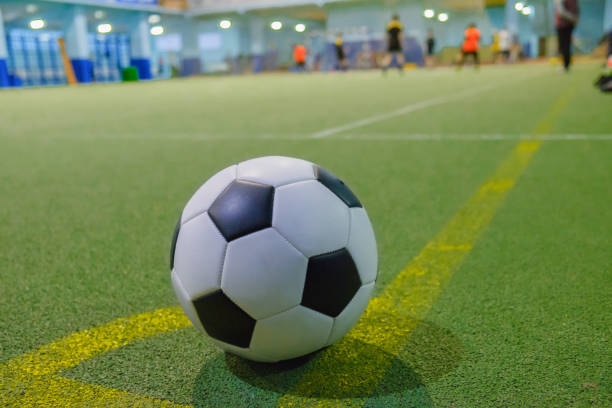 soccer ball on a corner kick line on an artificial green grass - futsal imagens e fotografias de stock