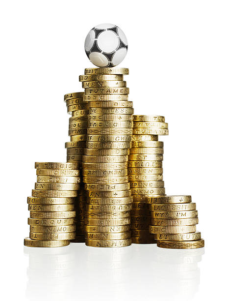 Soccer ball on gold coins stock photo