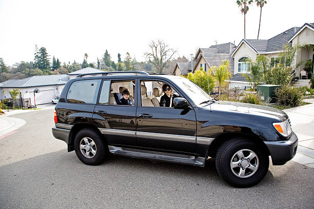 Soccer Mom Further Mom and child. sports utility vehicle stock pictures, royalty-free photos & images