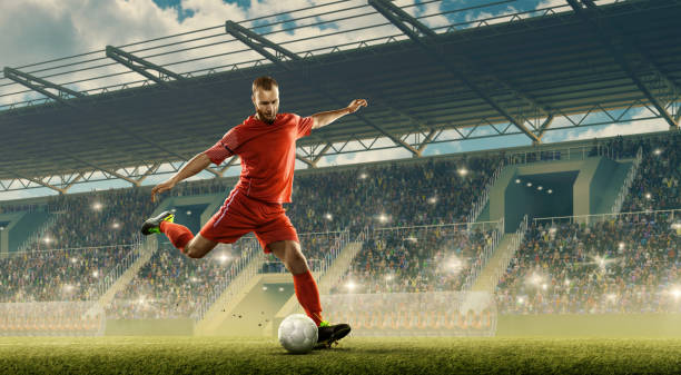 Soccer player in action a stadium Professional soccer player with a ball in action. Night soccer stadium with fans cheering and dramatic sky. Sports event kicking stock pictures, royalty-free photos & images