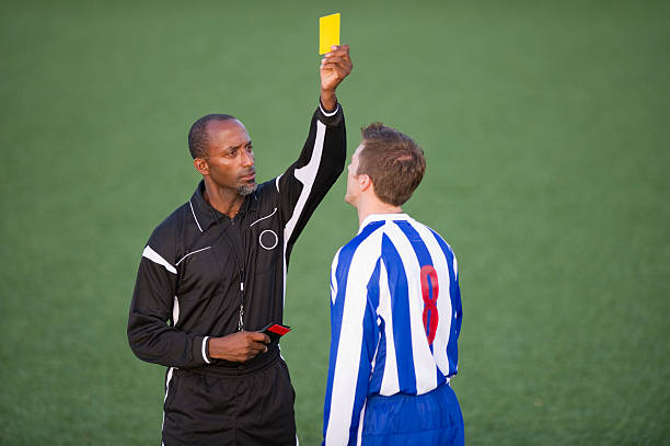 soccer player & referee - gele kaart stockfoto's en -beelden