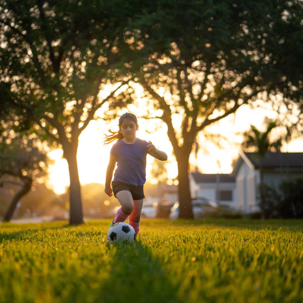 Soccer practice in the park at sunset Soccer practice in the park at sunset golden hour stock pictures, royalty-free photos & images