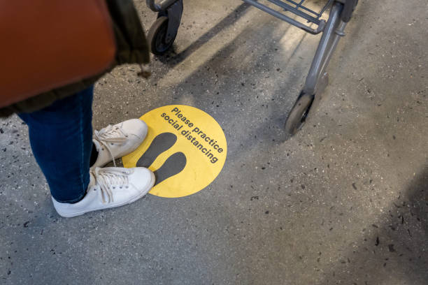 Social Distance Sign on the floor during COVID-19 stock photo