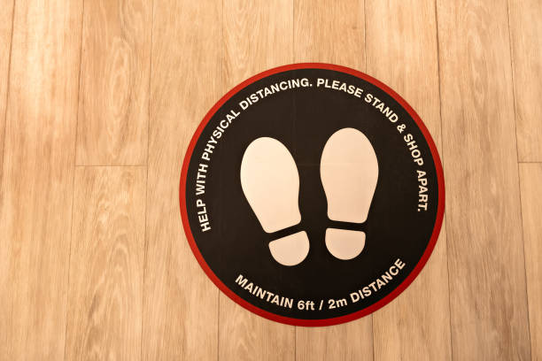 Social distancing in stores, malls or shops during pandemic or after virus. Protection customers. Sticker sign on floor stock photo