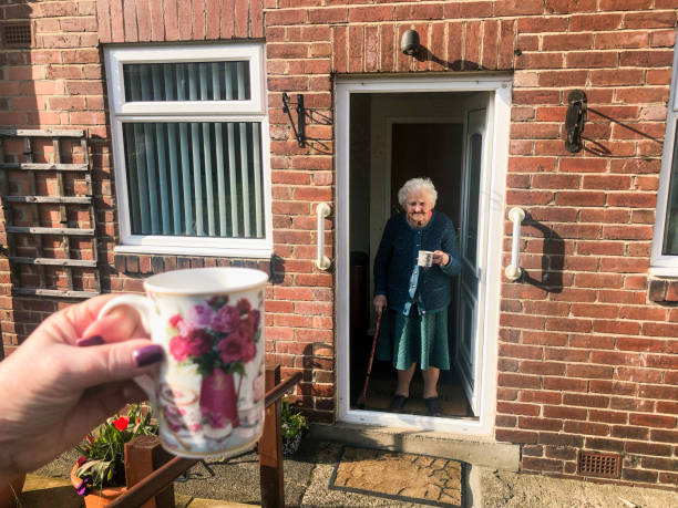 Social Distancing with Family Point of view angle of an unrecognisable person social distancing from her grandmother. She is sitting outside as her grandmother stands in the doorway of her house. county durham england stock pictures, royalty-free photos & images