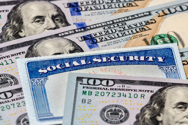 Social Security benefits identification card with 100 dollar bills closeup, background, copy space stimulus check stock pictures, royalty-free photos & images