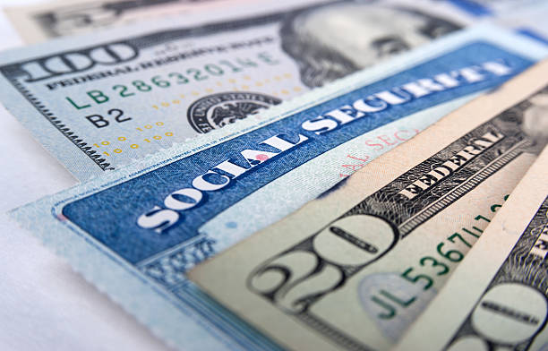 Social security card and American money dollar bills stock photo