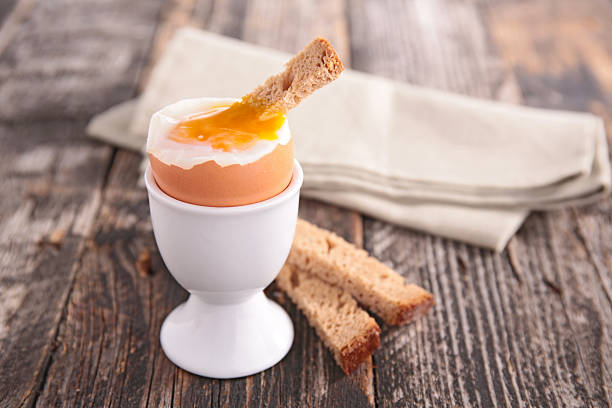 Soft boiled egg being served with slices of bread  soft-boiled egg stock pictures, royalty-free photos & images