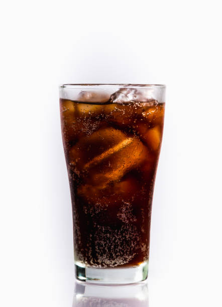 Soft drink Glass of soft drink with reflection on white background. cola stock pictures, royalty-free photos & images