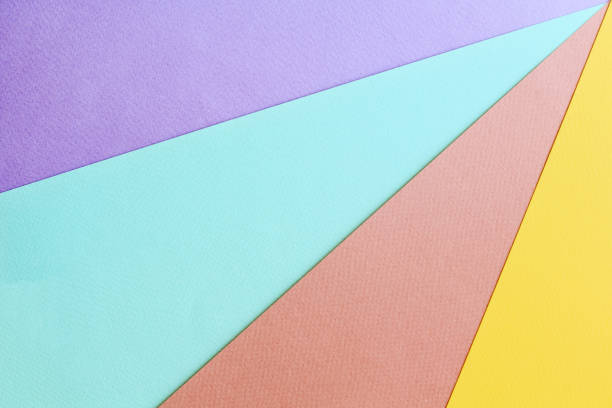 Soft geometric pastel background with multicolored diagonal rays made from watercolor paper. stock photo