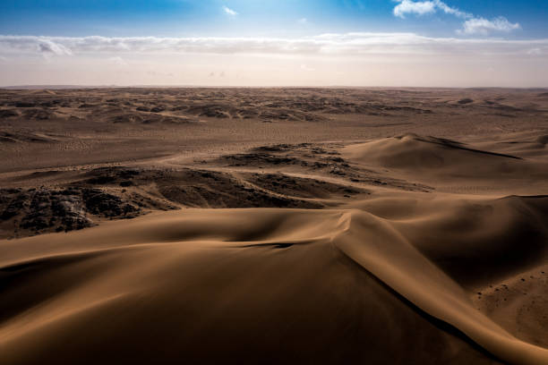 Soft shapes of wind-blown Namib desert dunes, Namibia stock photo