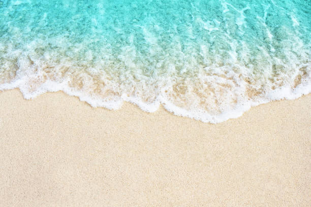Soft wave of blue ocean on the beach Soft blue ocean wave on sandy beach. Background. sea foam stock pictures, royalty-free photos & images