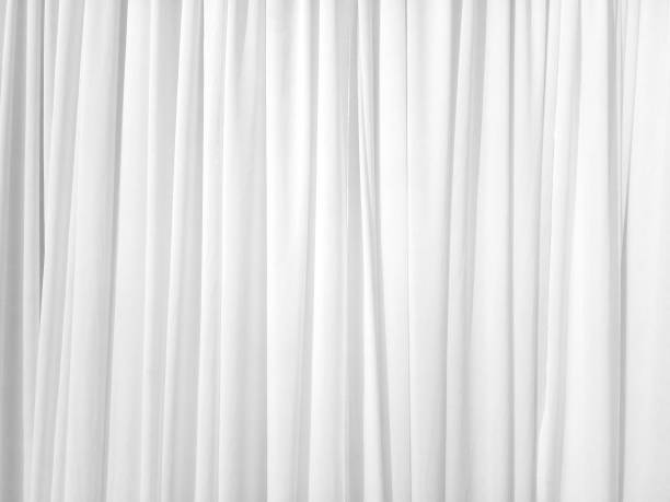 Soft white curtains are simple yet elegant for graphic design Soft white curtains are simple yet elegant for graphic design or wallpaper. Blurred cloth pattern with luxurious texture. Beautiful abstract background with smooth waves in a vintage style. curtain stock pictures, royalty-free photos & images