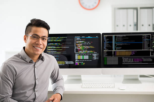 Software engineer Portrait of smiling young Vietnamese software engineer developer stock pictures, royalty-free photos & images
