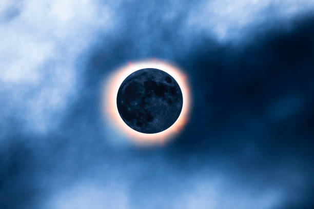 Solar eclipse in the sky with clouds of fog stock photo
