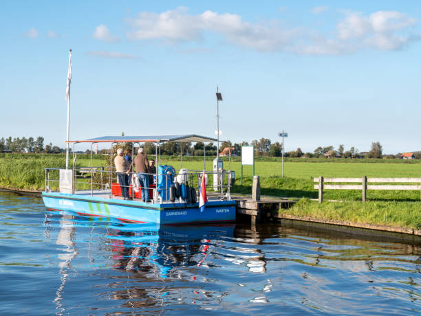 Solar energy foot ferry from Earnewald to Warten in nature reserve Alde Feanen, Friesland, Netherlands stock photo