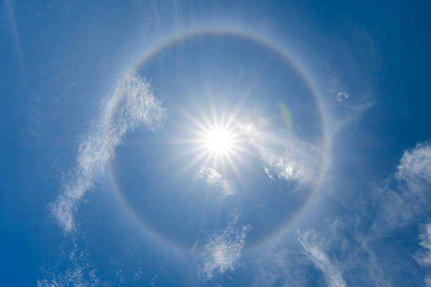 solar halo or antelia, creates around the sun a rainbow crown, meteorological phenomenon stock photo