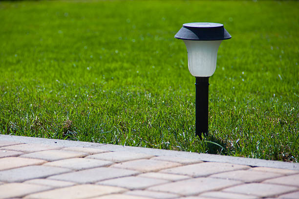 Solar Lantern near a paved garden path stock photo