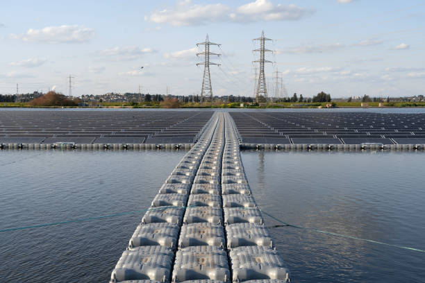 Solar panel farm on a fish pond for electricity generation stock photo
