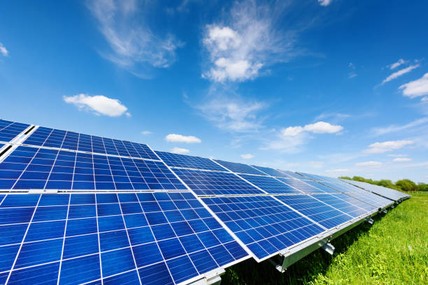 Solar panel on blue sky background Solar panel on blue sky background. Green grass and cloudy sky. Alternative energy concept solar panel stock pictures, royalty-free photos & images