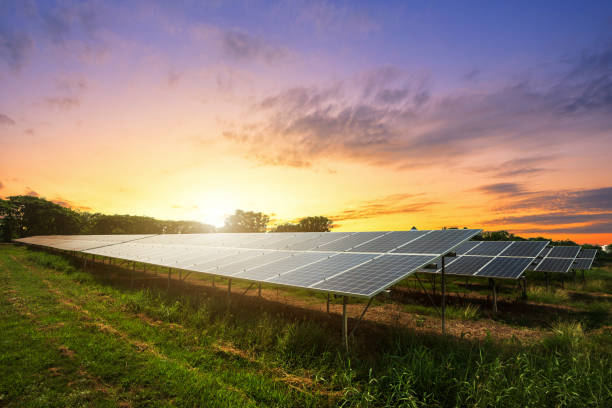 solar panel on dramatic sunset sky background, alternative energy concept - solar panels imagens e fotografias de stock