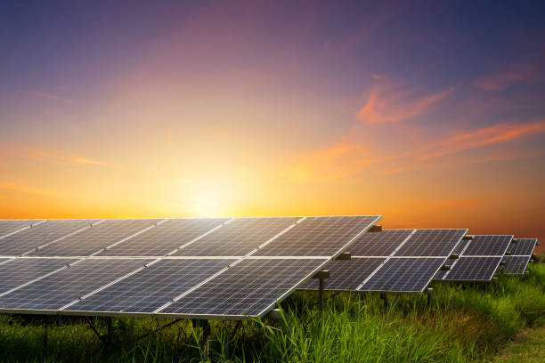 solar panel on dramatic sunset sky background, alternative energy concept - central solar imagens e fotografias de stock