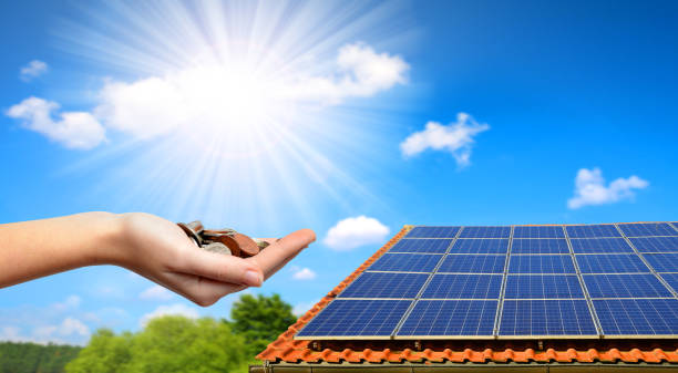 Solar panel on the roof of the house. Solar panel on the roof of the house and coins in hand. The concept of money saving and clean energy. solar panel photos stock pictures, royalty-free photos & images