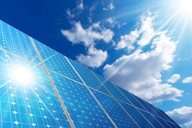 Solar Panels - Blue Sky Clouds and Sun Rays stock photo