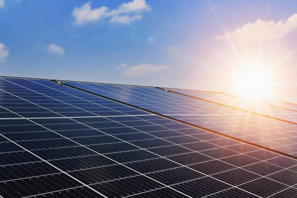 solar panels with sunset and blue sky background. clean power energy concept - painel solar imagens e fotografias de stock