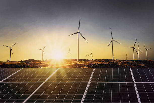 solar panels with wind turbine and sunset .concept power energy in nature - energias renováveis imagens e fotografias de stock