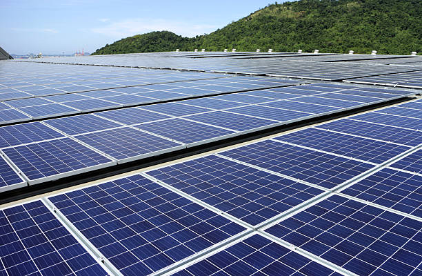 solar pv rooftop system mountain background - zonnepanelen warehouse stockfoto's en -beelden