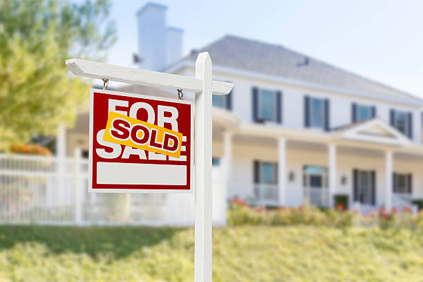 Sold Home For Sale Sign in Front of New House stock photo