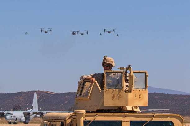 Soldier and squadron of helicopters flying at air show stock photo