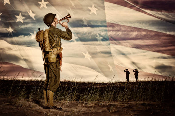 WWII Soldier Playing Taps With Flag Horizon stock photo