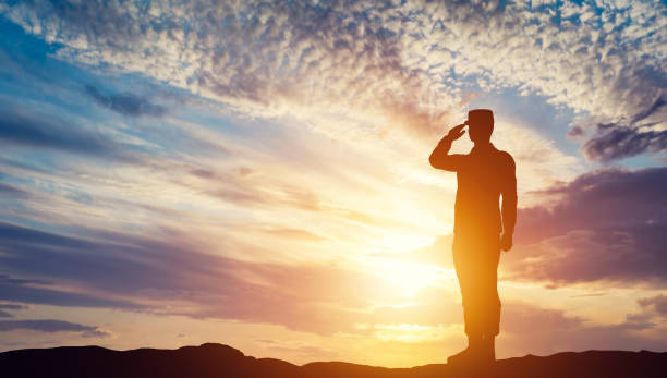 Soldier saluting at sunset. Army, salute, patriotic concept. Soldier saluting. Sunset sky, sun shining. Army, salute, patriotic concept. 3D illustration military stock pictures, royalty-free photos & images