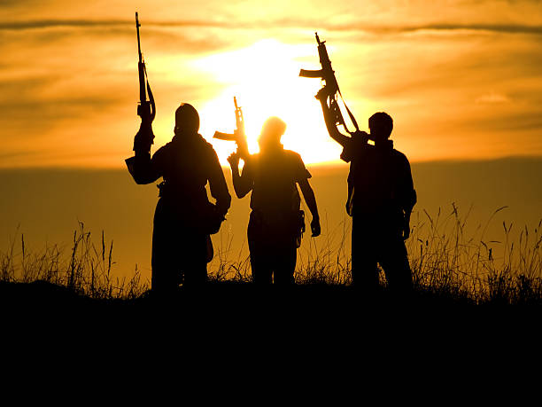soldiers against a sunset stock photo