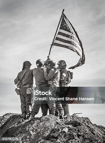 istock Soldiers Raising the US Flag 610782276
