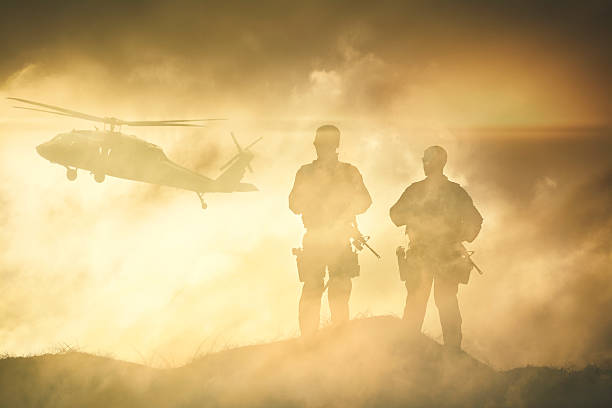 Soldiers wait for a Helicopter in Dust Storm stock photo